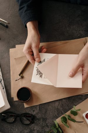 person-holding-white-printer-paper-3826684