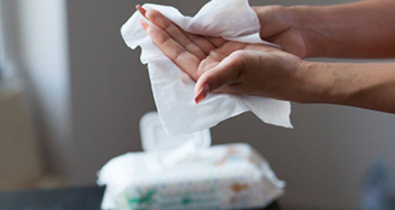 Female hands cleaning with wet wipes